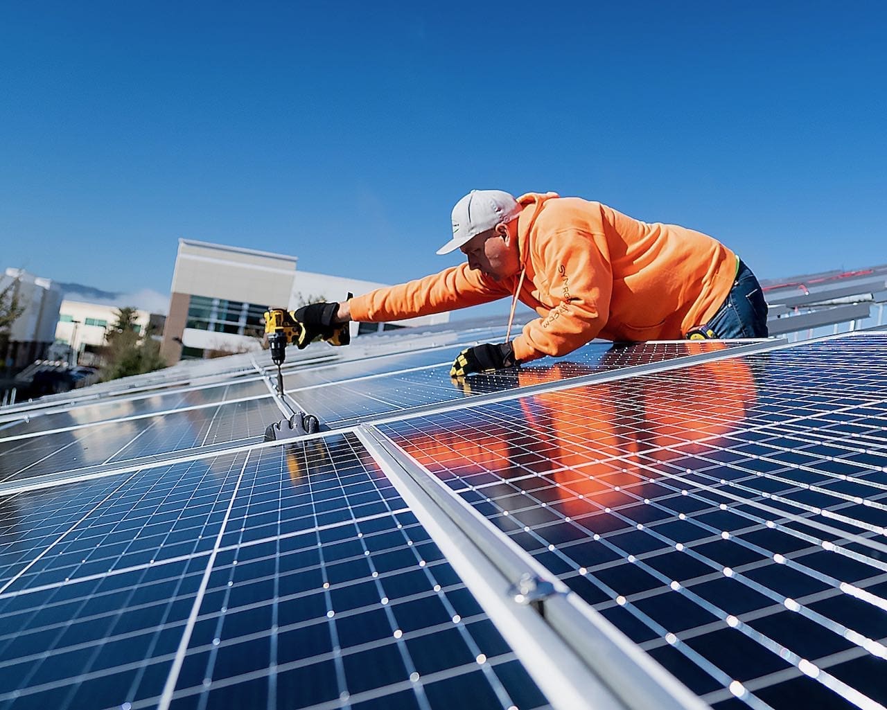 Jason-Piekarczyk-Solar-Company Jason Piekarczyk installing solar panels on a roof. He and his brother started Synergy Power, a solar company in Livermore CA